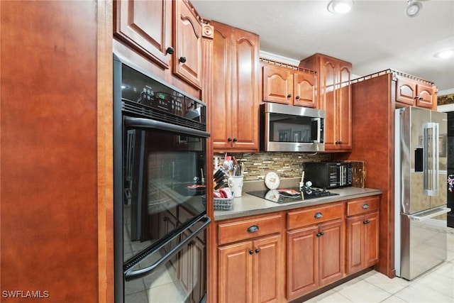 kitchen featuring light tile patterned floors, decorative backsplash, and black appliances