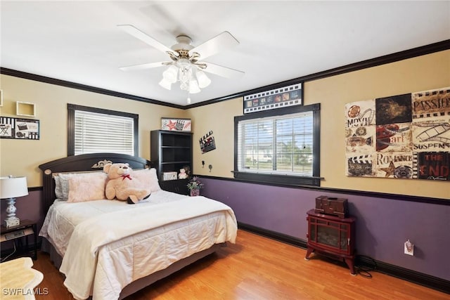 bedroom featuring crown molding, ceiling fan, and light hardwood / wood-style floors