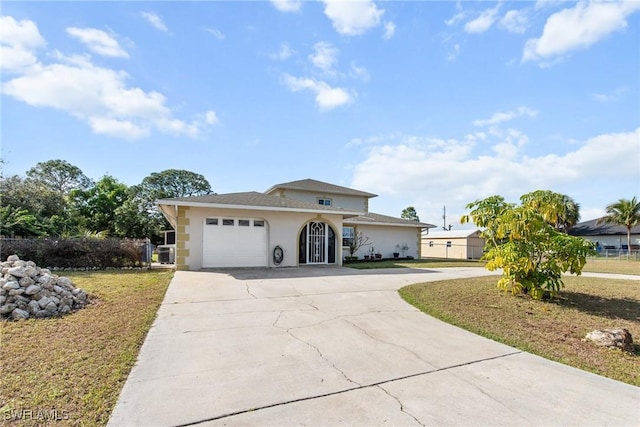 view of front of house featuring a garage and a front lawn