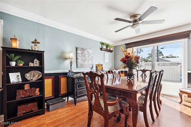 dining area with crown molding, ceiling fan, and wood-type flooring