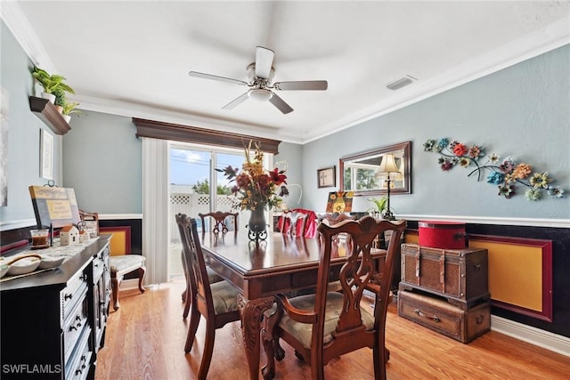 dining area with crown molding, ceiling fan, and light hardwood / wood-style flooring