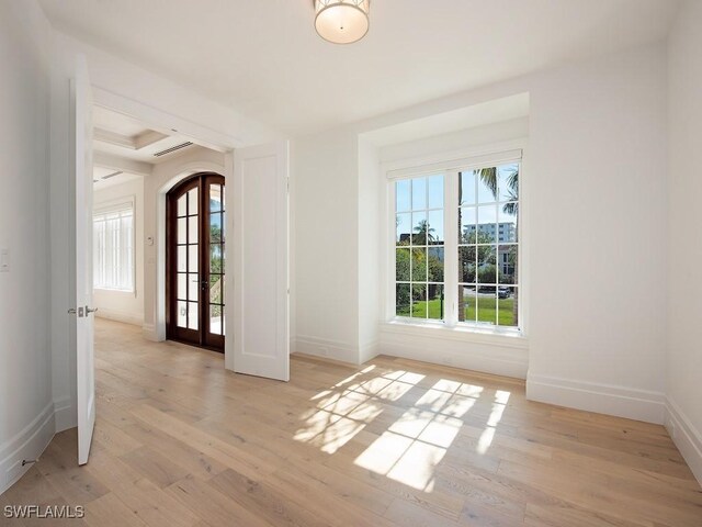 interior space with light hardwood / wood-style floors and french doors