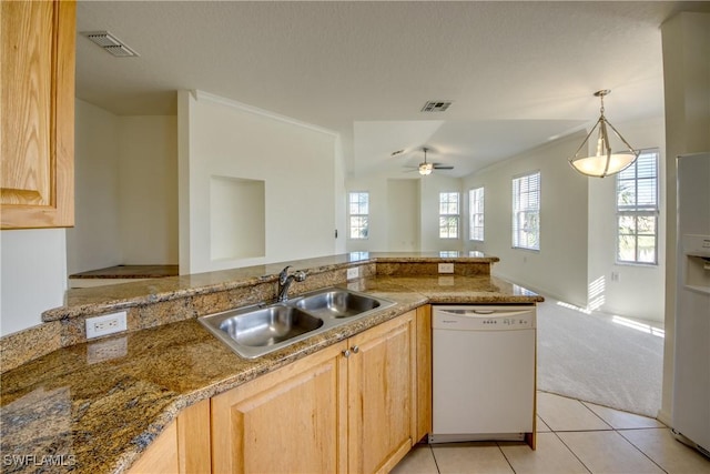 kitchen featuring sink, light brown cabinets, white appliances, light carpet, and ceiling fan