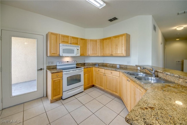 kitchen with white appliances, kitchen peninsula, light stone countertops, light tile patterned floors, and sink