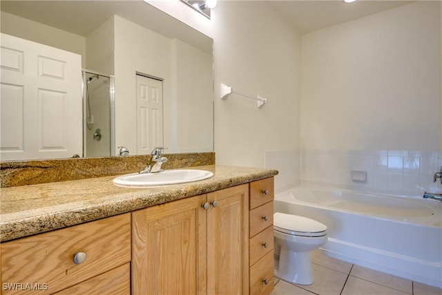 bathroom featuring toilet, a washtub, tile patterned flooring, and vanity