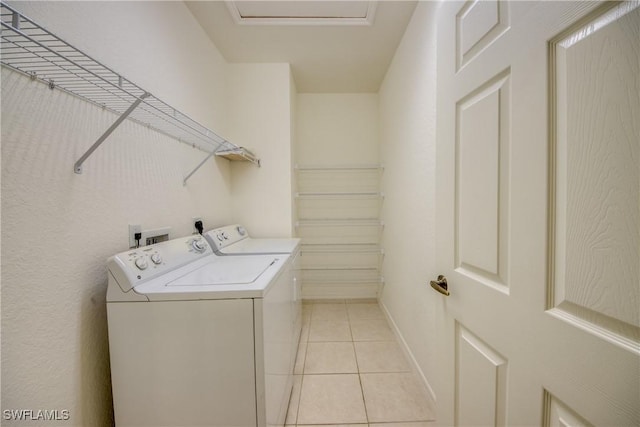 washroom featuring washer and dryer and light tile patterned floors