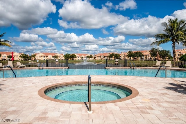 view of swimming pool featuring a community hot tub