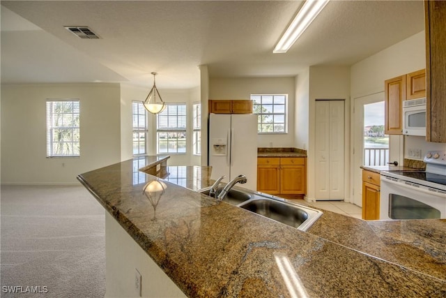 kitchen with white appliances, pendant lighting, a large island, light colored carpet, and sink