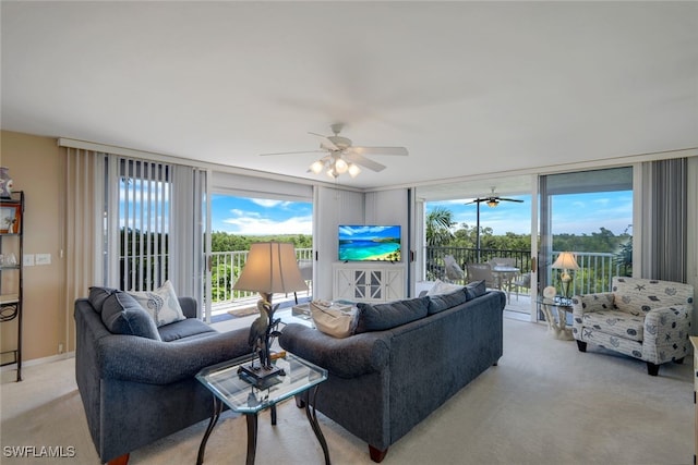 carpeted living room featuring floor to ceiling windows and ceiling fan