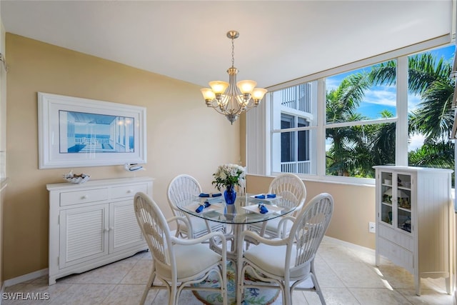 dining area featuring light tile patterned flooring and a chandelier