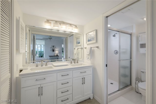 bathroom featuring walk in shower, ceiling fan, vanity, and toilet