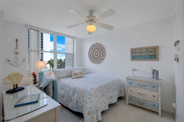 bedroom with ceiling fan and light carpet