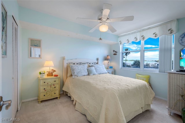 carpeted bedroom with a closet and ceiling fan