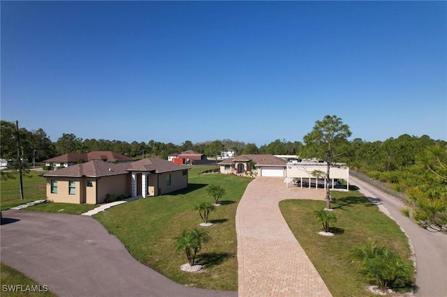 view of front of house with a front yard and a garage