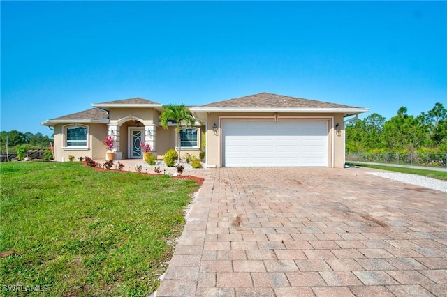 view of front of house featuring a front yard and a garage