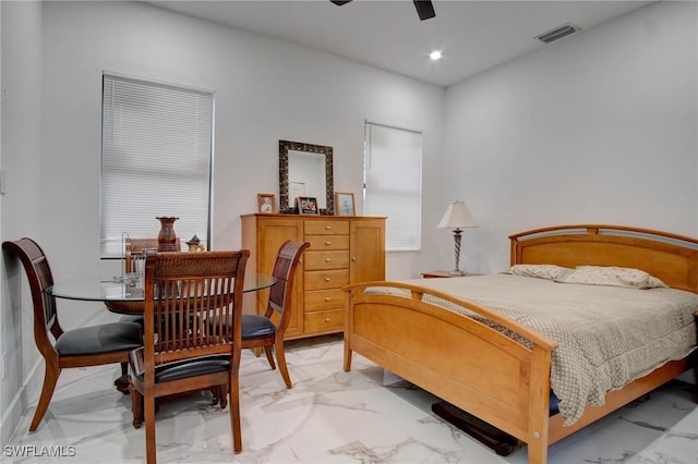 bedroom featuring multiple windows and ceiling fan