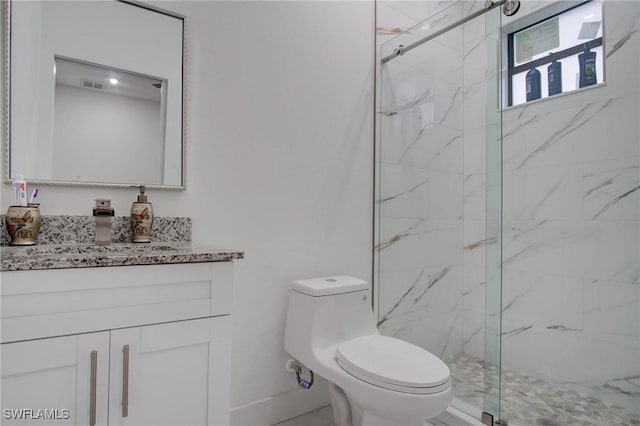 bathroom with vanity, toilet, and a shower with shower door