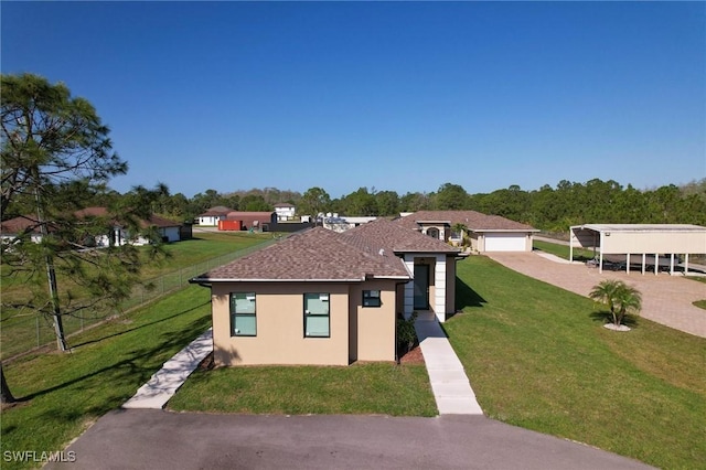 view of front facade with a front lawn and a carport