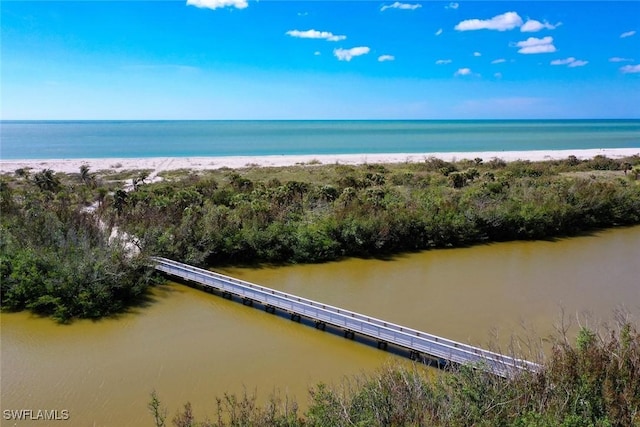 drone / aerial view with a beach view and a water view