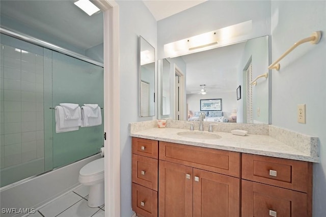 full bathroom featuring ceiling fan, tile patterned flooring, enclosed tub / shower combo, toilet, and vanity