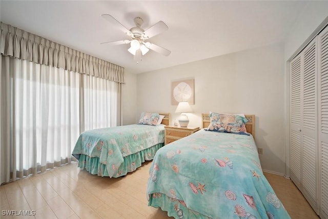 bedroom with ceiling fan and a closet