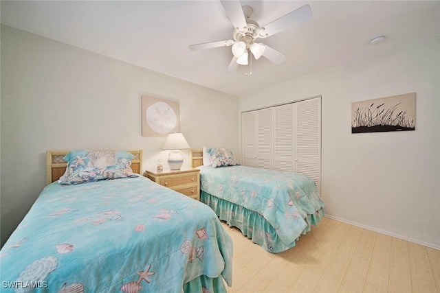 bedroom featuring light wood-type flooring, a closet, and ceiling fan