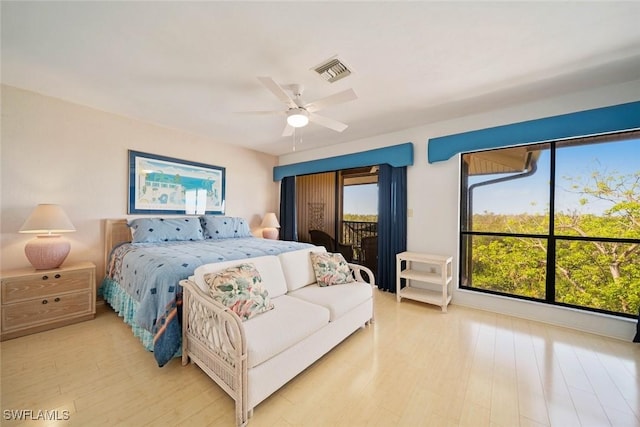 bedroom featuring access to outside, light hardwood / wood-style flooring, and ceiling fan