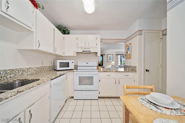 kitchen featuring white cabinetry, light tile patterned floors, light stone countertops, and white appliances