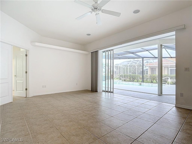 spare room featuring light tile patterned floors and ceiling fan