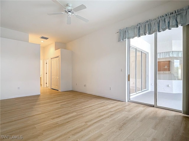 spare room with ceiling fan and light wood-type flooring