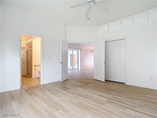 unfurnished bedroom with ceiling fan, ensuite bathroom, light hardwood / wood-style floors, and a closet