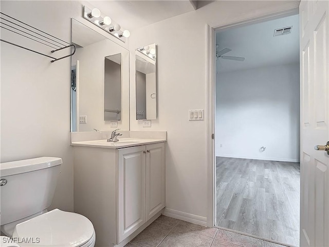 bathroom with vanity, ceiling fan, and toilet