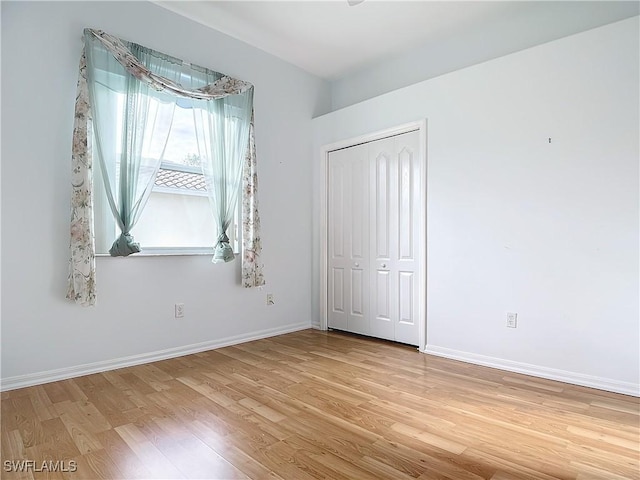 unfurnished bedroom with a closet and light hardwood / wood-style flooring