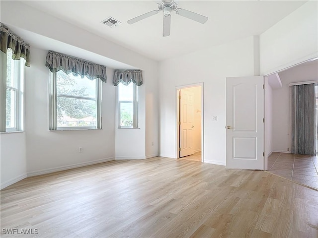 spare room featuring light hardwood / wood-style floors and ceiling fan