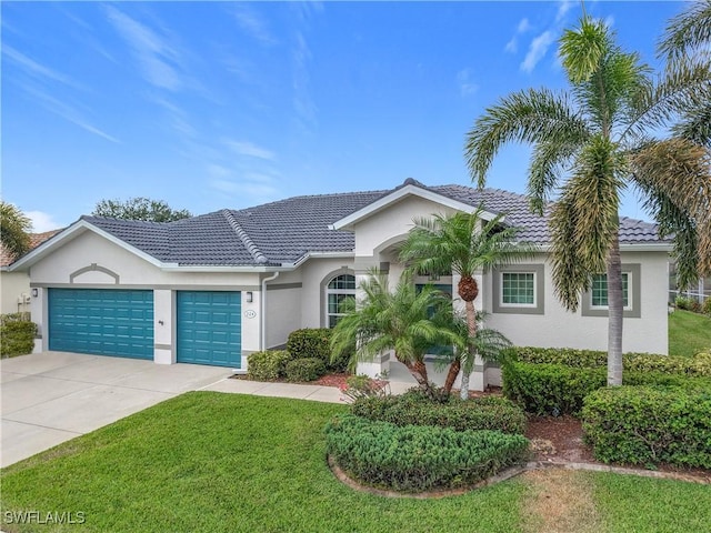 single story home featuring a garage and a front yard