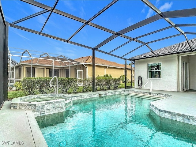 view of pool featuring an in ground hot tub and a lanai