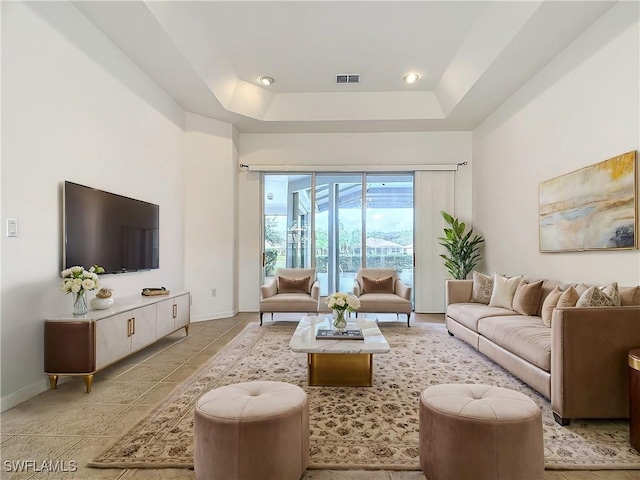 living room featuring a tray ceiling