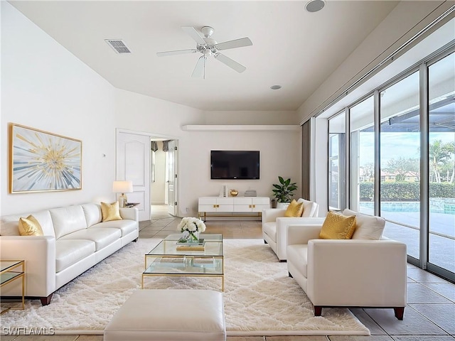 tiled living room with ceiling fan