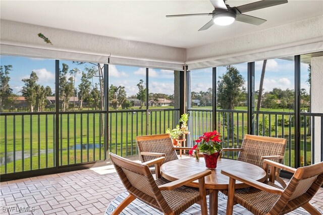 sunroom featuring ceiling fan