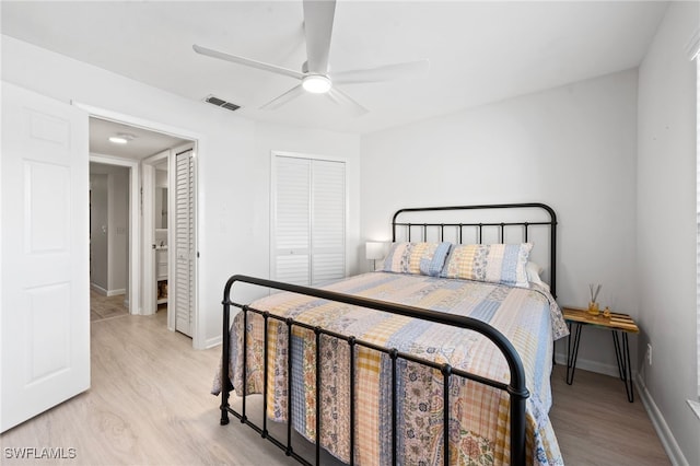 bedroom featuring ceiling fan, light hardwood / wood-style floors, and a closet