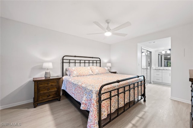 bedroom featuring light wood-type flooring, connected bathroom, and ceiling fan