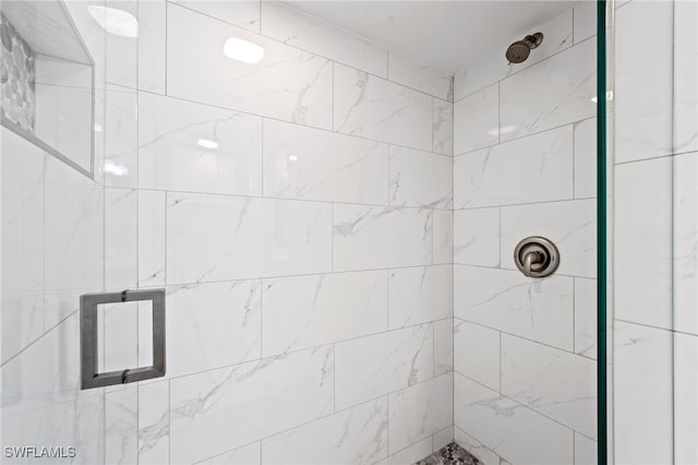 bathroom with tiled shower