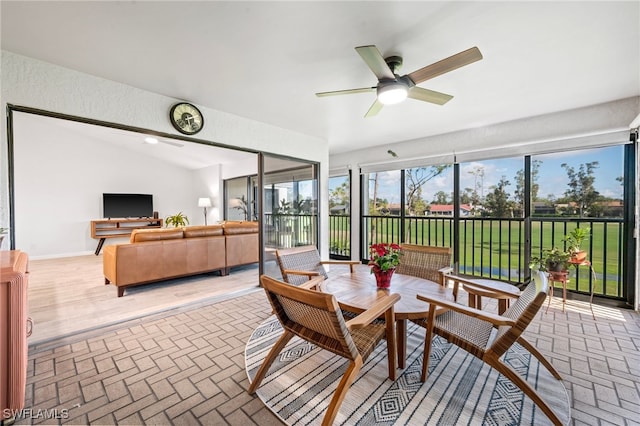 sunroom / solarium with ceiling fan and lofted ceiling