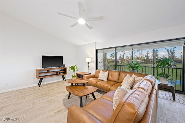 living room with ceiling fan, light wood-type flooring, and lofted ceiling