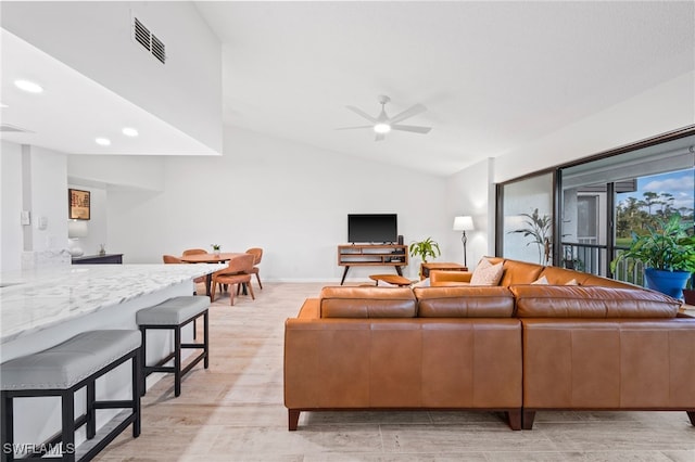 living room with ceiling fan, light hardwood / wood-style flooring, and lofted ceiling