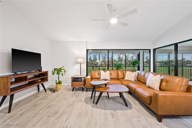 living room with ceiling fan, light hardwood / wood-style floors, and lofted ceiling