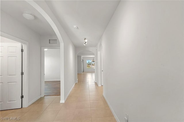 corridor with light tile patterned flooring