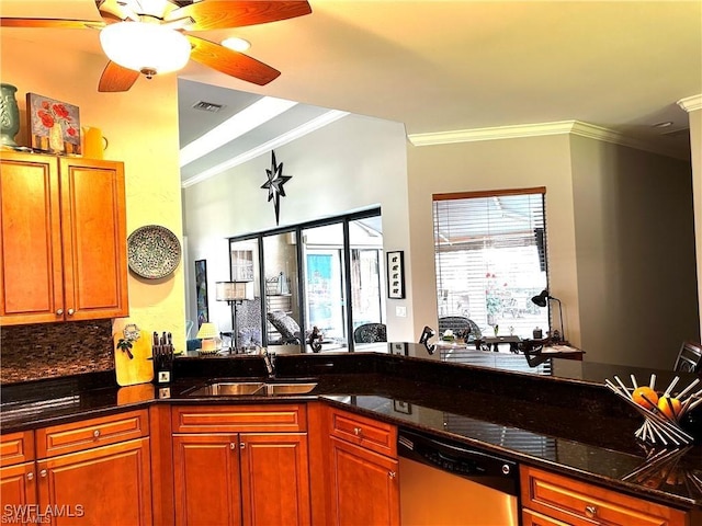 kitchen with dark stone counters, dishwasher, sink, and crown molding