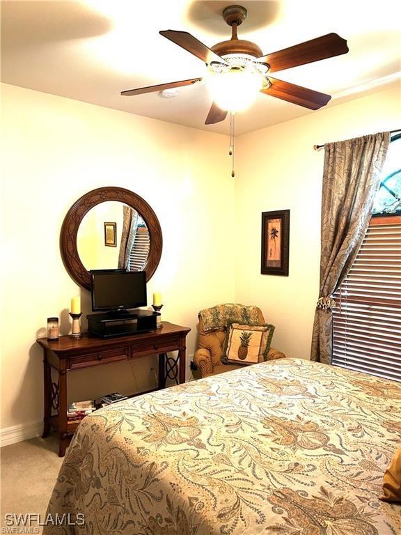 carpeted bedroom with ceiling fan