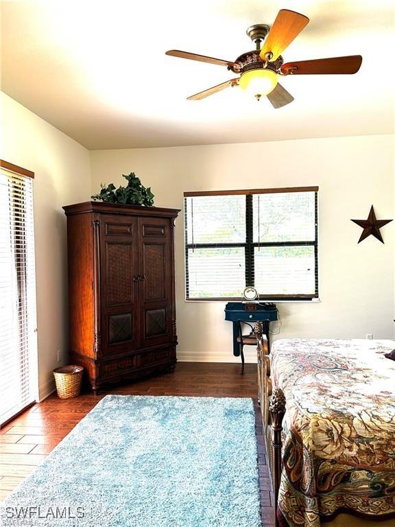 bedroom with ceiling fan and dark wood-type flooring